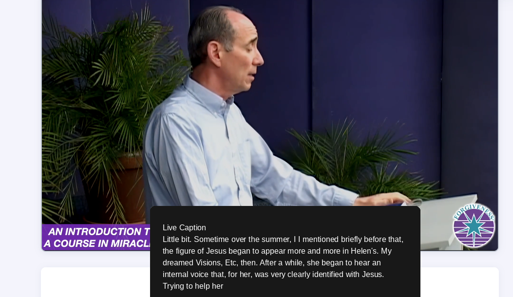 A lecture video playing with the black Live Caption box over the bottom of the picture, showing the words being spoken.